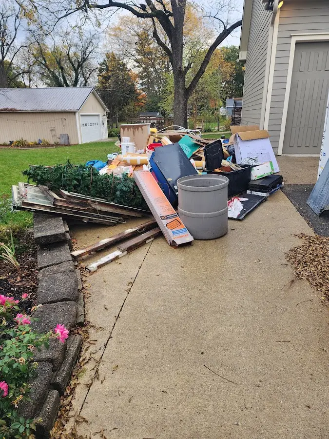 Dumpster being loaded with debris for Estate Cleanout Dumpster Rental in Plymouth